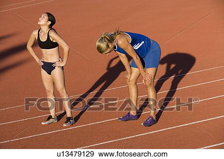 Stock Photo - Female athletes after completed run. Fotosearch