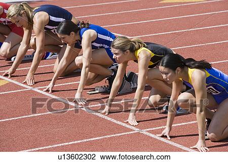 Female athletes in starting blocks, ready to run View Large Photo Image Stock Image - Female athletes in starting blocks, ready to run. Fotosearch