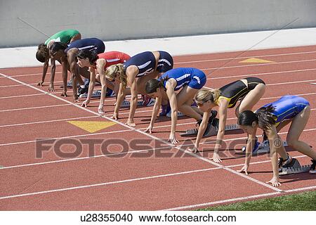 Female athletes in starting blocks, ready to run View Large Photo Image Stock Image - Female athletes in starting blocks, ready to run. Fotosearch