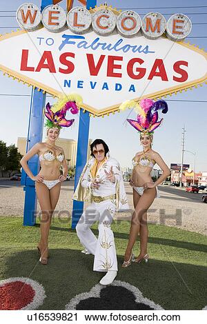 Female dancers and Elvis impersonator posing in front of Las Vegas welcome sign, Nevada, USA View Large Photo Image Stock Image - Female dancers and Elvis impersonator posing in front of Las Vegas welcome sign, Nevada, USA. Fotosearch