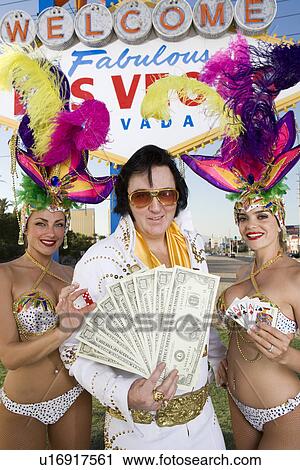 Female dancers and Elvis impersonator posing in front of Las Vegas welcome sign, Nevada, USA View Large Photo Image Stock Image - Female dancers and Elvis impersonator posing in front of Las Vegas welcome sign, Nevada, USA. Fotosearch
