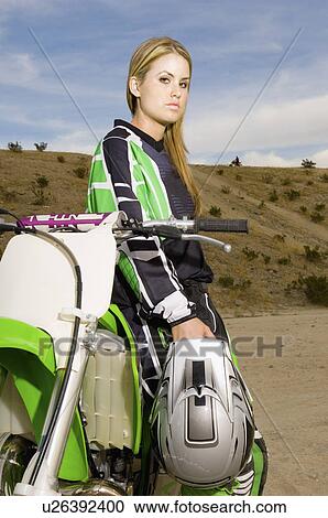 Female motocross racer with bike in desert, (portrait) View Large Photo Image Stock Image - Female motocross racer with bike in desert, (portrait). Fotosearch
