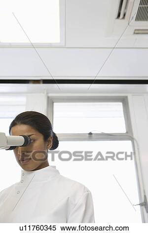 Female scientist using microscope in laboratory View Large Photo Image Stock Photography - Female scientist using microscope in laboratory. Fotosearch