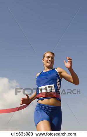 Female track athlete crossing finishing line View Large Photo Image Stock Image - Female track athlete crossing finishing line. Fotosearch