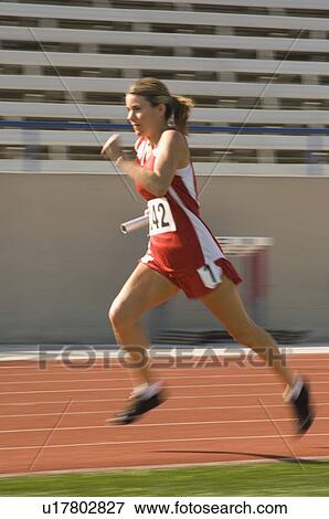 Stock Photo - Female track athlete sprinting. Fotosearch