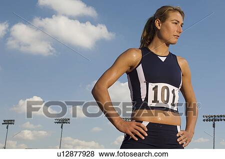 Female track athlete standing on track View Large Photo Image Stock Photo - Female track athlete standing on track. Fotosearch