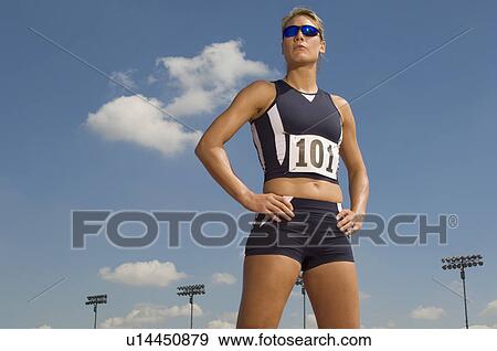 Female track athlete standing on track View Large Photo Image Stock Photo - Female track athlete standing on track. Fotosearch