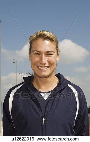 Female track athlete standing on track, portrait View Large Photo Image Stock Photograph - Female track athlete standing on track, portrait. Fotosearch