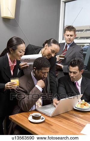 Five business people using laptop in office meeting View Large Photo Image Stock Image - Five business people using laptop in office meeting. Fotosearch