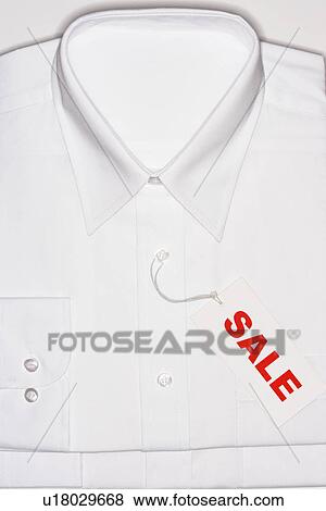 Stock Photo - Folded white shirt with 'sale' tag. Fotosearch
