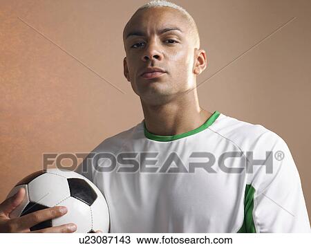 Football player holding ball, portrait View Large Photo Image Stock Image - Football player holding ball, portrait. Fotosearch