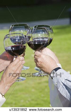 Stock Image - Four people raising toast. Fotosearch