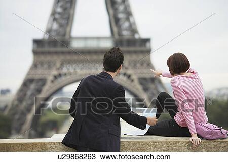 France, Paris, couple looking at map in front of Eiffel Tower, back view View Large Photo Image Stock Image - France, Paris, couple looking at map in front of Eiffel Tower, back view. Fotosearch