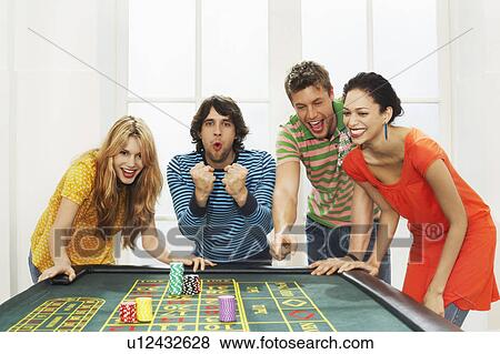 Friends celebrating win on roulette table View Large Photo Image Stock Photo - Friends celebrating win on roulette table. Fotosearch