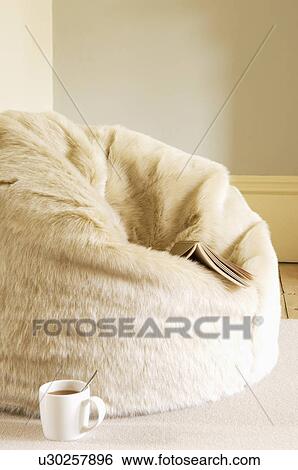 Stock Photograph - Furry Beanbag With Book and Coffee Cup. Fotosearch