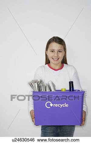 Girl (10-12) holding recycling container, smiling View Large Photo Image Stock Photograph - Girl (10-12) holding recycling container, smiling. Fotosearch