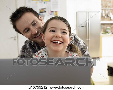 Girl (3-6) using laptop with father at home View Large Photo Image Stock Image - Girl (3-6) using laptop with father at home. Fotosearch