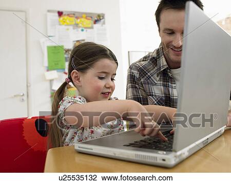 Girl (3-6) using laptop with father at home View Large Photo Image Stock Image - Girl (3-6) using laptop with father at home. Fotosearch
