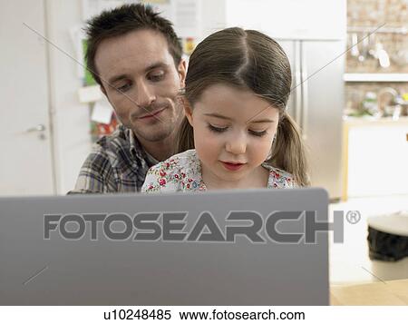 Girl (3-6) using laptop with father at home View Large Photo Image Stock Photography - Girl (3-6) using laptop with father at home. Fotosearch