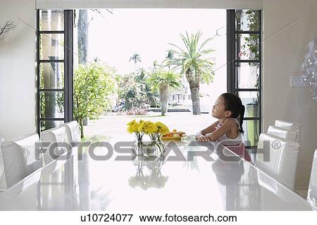 Girl (5-6 years) sitting at dining table, side view View Large Photo Image Stock Photo - Girl (5-6 years) sitting at dining table, side view. Fotosearch