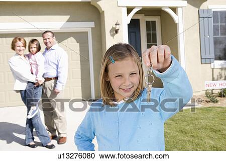 Girl (7-9) holding keys, rest of family in background View Large Photo Image Stock Image - Girl (7-9) holding keys, rest of family in background. Fotosearch