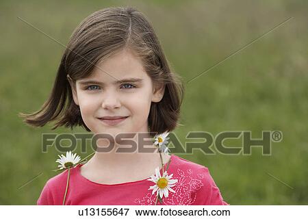 Girl (7-9) wearing ring of flowers in meadow, portrait View Large Photo Image Stock Photo - Girl (7-9) wearing ring of flowers in meadow, portrait. Fotosearch