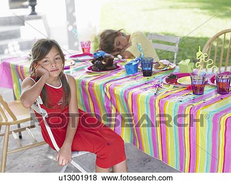 Girl and boy (7-9) at table after birthday party, boy sleeping View Large Photo Image Stock Photo - Girl and boy (7-9) at table after birthday party, boy sleeping. Fotosearch