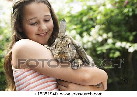 Stock Image - Girl Holding Rabbit. Fotosearch