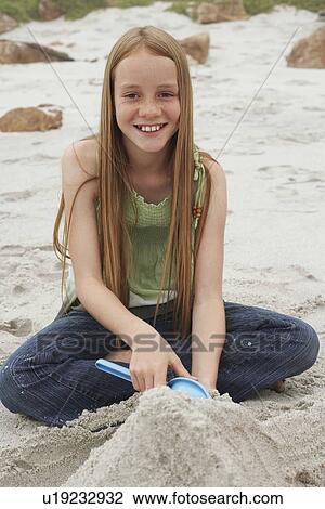 Stock Image - Girl Playing on Beach. Fotosearch