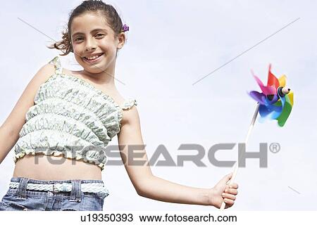 Stock Image - Girl Playing With Pinwheel. Fotosearch