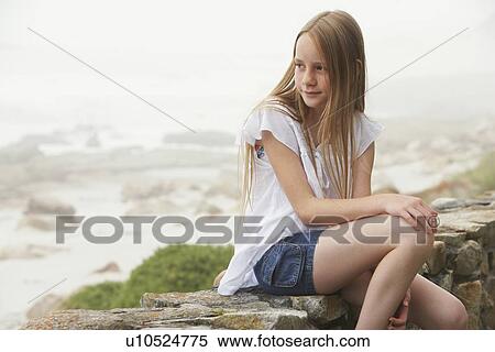 Stock Photography - Girl Sitting on Wall. Fotosearch