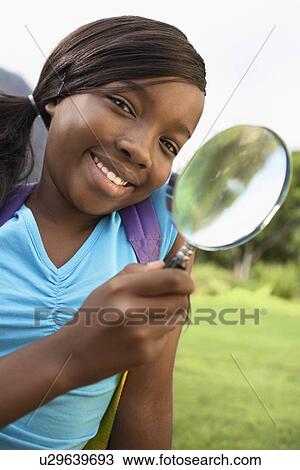 Stock Image - Girl Using Magnifying Glass. Fotosearch