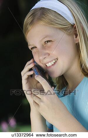 Picture - Girl with mobile phone, smiling. Fotosearch