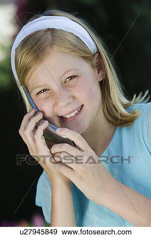 Girl with mobile phone, smiling View Large Photo Image Stock Photo - Girl with mobile phone, smiling. Fotosearch