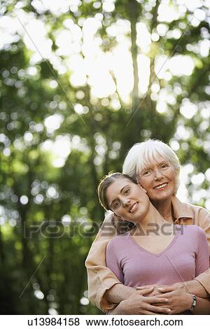 Stock Photo - Grandmother and Granddaughter in back yard, portrait. Fotosearch