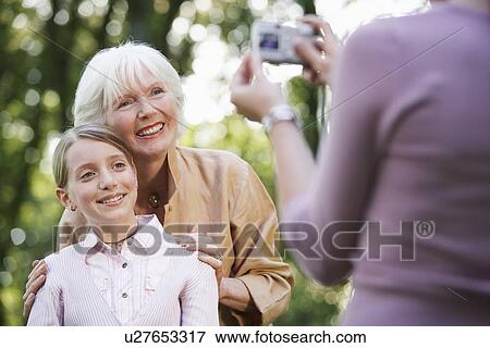 Grandmother With Granddaughter Posing For Photograph View Large Photo Image Stock Photo - Grandmother With Granddaughter Posing For Photograph. Fotosearch