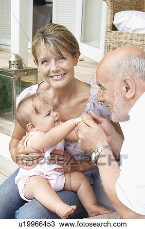 Grandparents playing with granddaughter on porch View Large Photo Image Stock Image - Grandparents playing with granddaughter on porch. Fotosearch