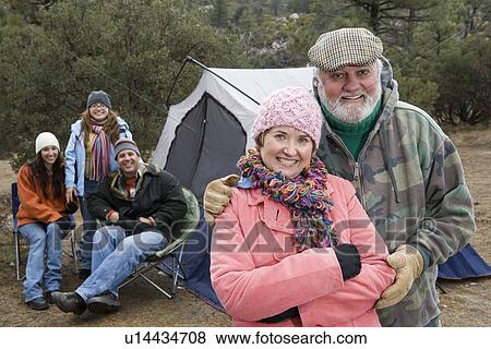 Stock Photo - Grandparents with family on camping trip, portrait. Fotosearch