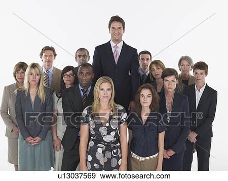Stock Photo - Group of businesspeople, man standing taller. Fotosearch