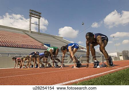Group of female track athletes on starting blocks View Large Photo Image Picture - Group of female track athletes on starting blocks. Fotosearch