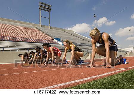 Group of female track athletes on starting blocks View Large Photo Image Stock Image - Group of female track athletes on starting blocks. Fotosearch