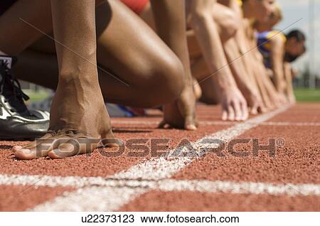 Group of female track athletes on starting blocks View Large Photo Image Stock Image - Group of female track athletes on starting blocks. Fotosearch