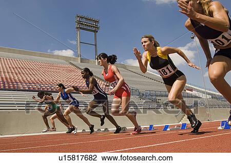 Stock Image - Group of female track athletes sprinting. Fotosearch