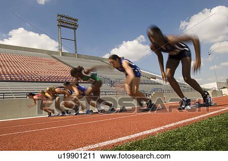 Stock Image - Group of female track athletes sprinting. Fotosearch