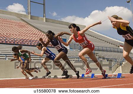 Stock Photo - Group of female track athletes sprinting. Fotosearch