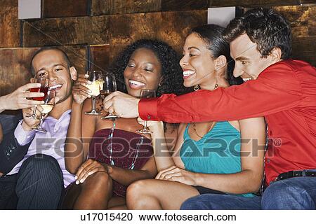 Group of friends toasting, sitting in bar View Large Photo Image Stock Image - Group of friends toasting, sitting in bar. Fotosearch