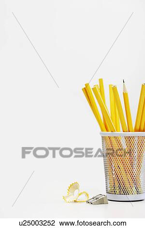 Stock Image - Group of yellow pencils in holder by sharpener. Fotosearch