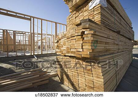 Stock Photo - House construction and stack of planks. Fotosearch