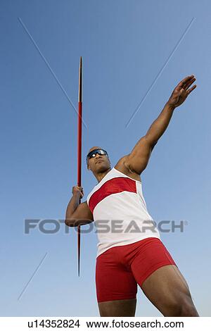 Javelin throwing, low angle view View Large Photo Image Picture - Javelin throwing, low angle view. Fotosearch