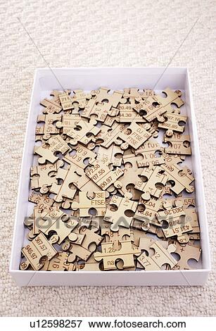 Jigsaw puzzle pieces in box, elevated view View Large Photo Image Stock Photo - Jigsaw puzzle pieces in box, elevated view. Fotosearch